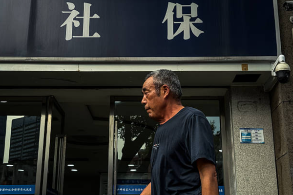 2025年9月2日，重庆，一位白发苍苍的老人走过人力资源和社会保障局的办公室。 (Photo by Cheng Xin/Getty Images)
