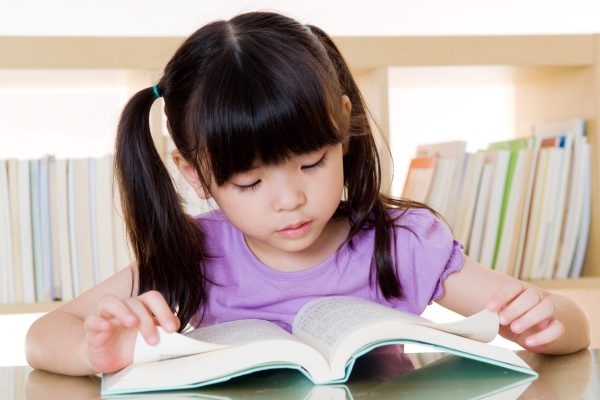 Asian girl reading book