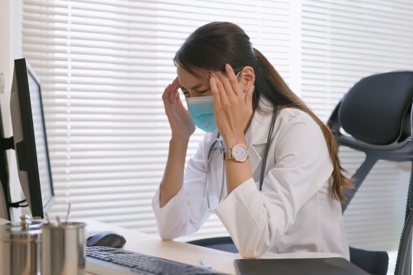 Woman doctor has stress headache