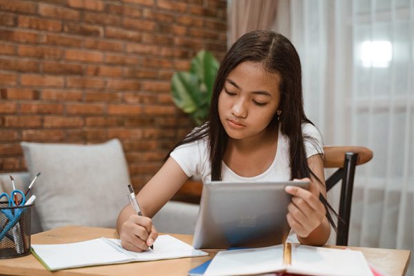portrait of young teenager junior high school student studying at home