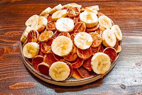 A plate of poffertjes, traditional Dutch Mini Pancakes served wi